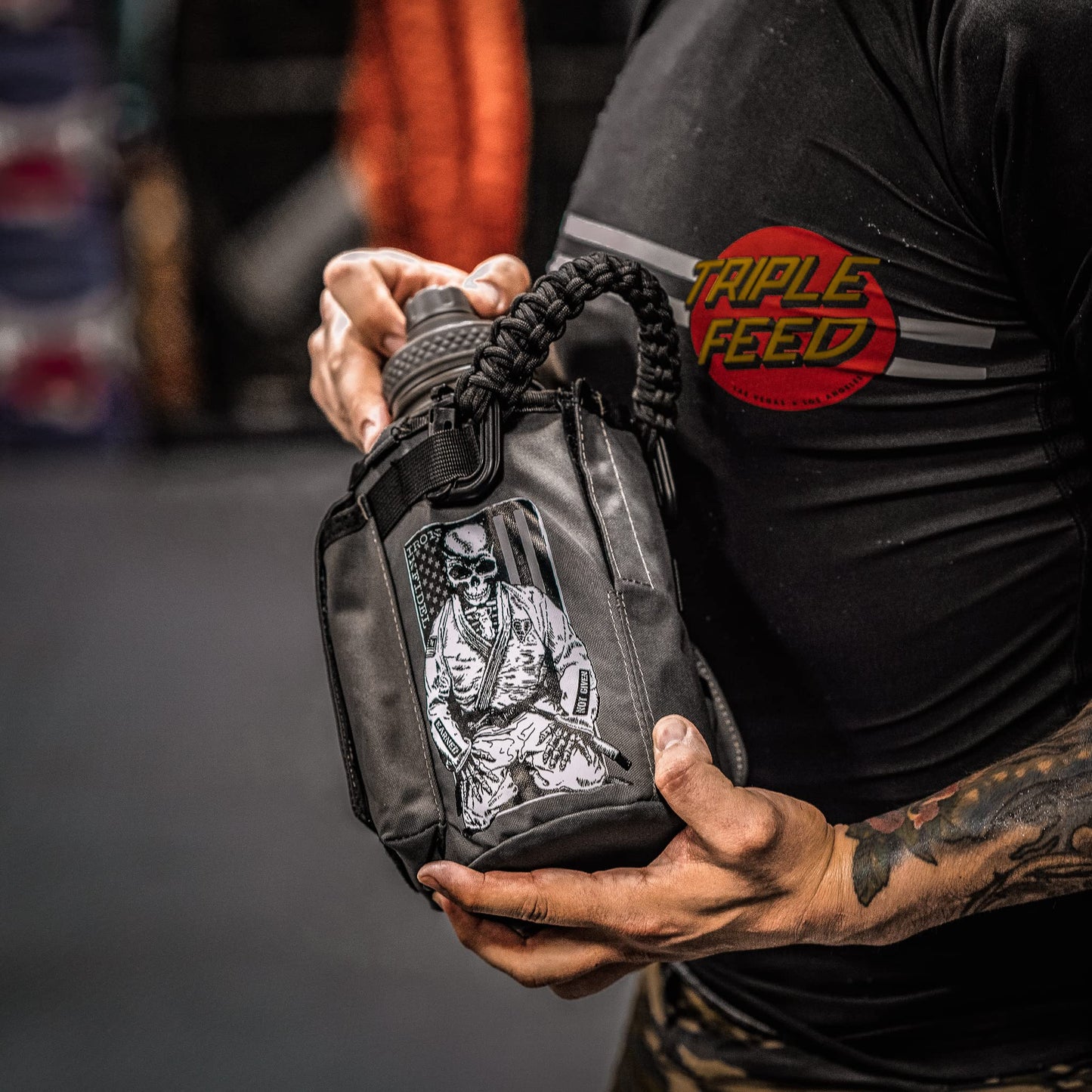 Iron Infidel Battle Bottle - Half Gallon Water Bottle Insulated, 64 oz Stainless Steel Water Jug with Handle - Gym Water Bottle for Men with Rugged Sleeve for Storage (Earned, Not Given 2 Liter)